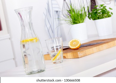 Glass And Carafe With Refreshing Lemonade On A Kitchen Counter