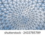 Glass ceiling in blue sky sunlight, abstract. Glass roof of the building. Geometrical ceiling, limpid round ceiling. Glass roof of the building over blue sky, transparent roof, skylight roof