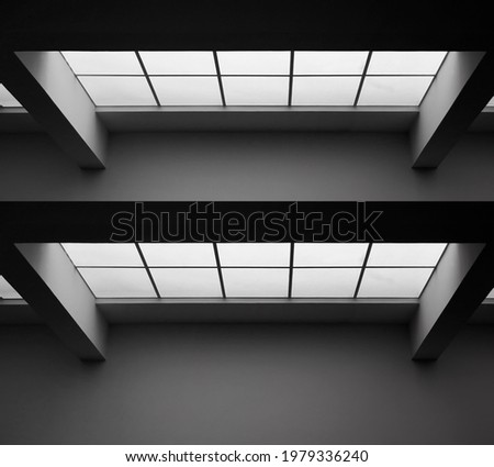 Glass ceiling with frames and panels. Abstract modern business architecture. Interior of commerical real estate. Office building. Regular geometrical background featuring girders and rectangular tiles