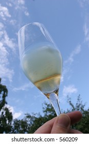 Glass of champagne against blue sky