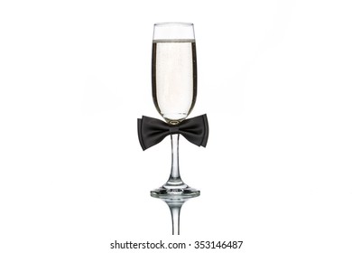 Glass Of Champagne With Black Bow Tie On White Background