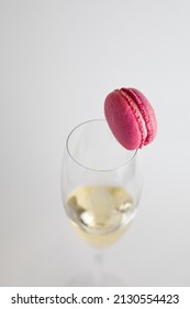 Glass Of Champagne With Macaron On Top