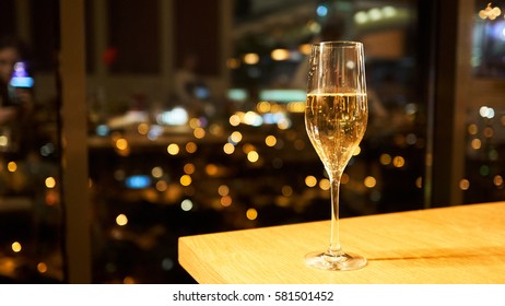 A glass of champagne on a table in a restaurant.