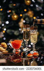 glass of champagne with red caviar appetizer cracker, butter and red caviar. Festive drink. Valentins or Christmas concept. - Shutterstock ID 2220736301