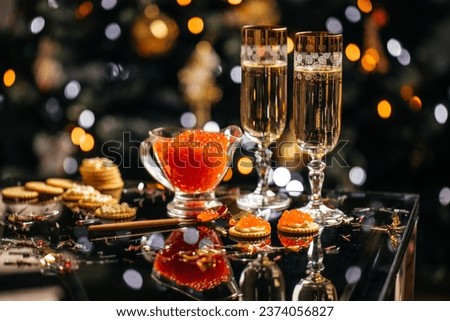 glass of champagne with red caviar appetizer cracker, butter and red caviar. banner, menu, recipe. selective focus, place for text.