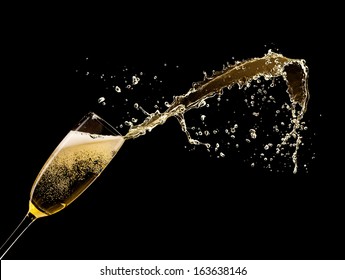 Glass of champagne with splash, isolated on black