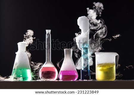 Glass in a chemical laboratory filled with colored liquid during the reaction 