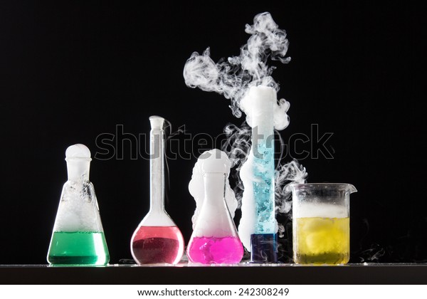 Glass in a chemical laboratory\
filled with colored liquid during the reaction - studio\
shoot
