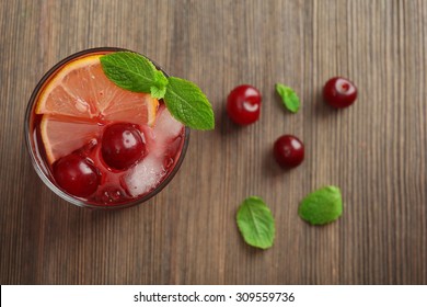 Glass Of Cherry Juice On Wooden Table, Top View