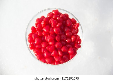 Glass Of Cinnamon Candy On Snow Background