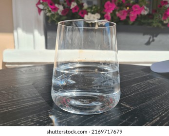Glass of clean cold water on table in a cafe. Drinking regimen and thirst concept - Shutterstock ID 2169717679