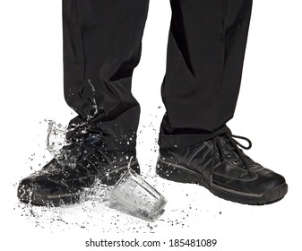 Glass with clear water falls at the feet of a man. Drink spills after falling on a shoe businessman. The detailed look at part of Inept waiter isolated on white background. Accident with beverage.