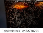 glass of coca cola with ice, closeup horizontal