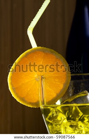 Glass with cocktail on wood background
