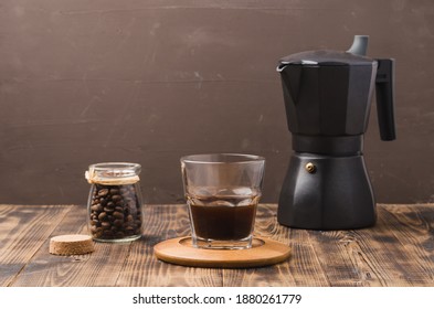 Glass Of Cofee With Cofee Beans And Black  Maker. 