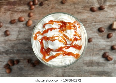 Glass Of Coffee With Caramel Topping On Wooden Background, Top View