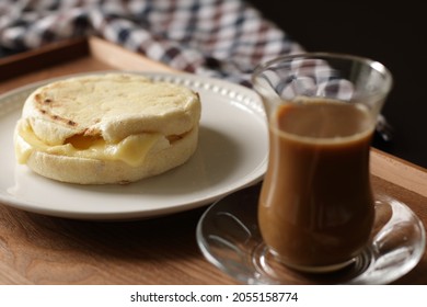 Glass Of Coffee And Cheese In English Muffin On The Table