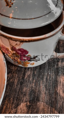 Similar – A painted ceramic milk jug next to an empty white cup