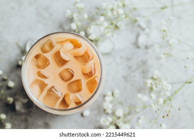 A Glass Of Cold Iced Coffee On A Gray Background Shot From Above.