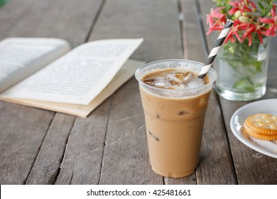 Glass Of Cold Iced Coffee Put On Old Wood Table.