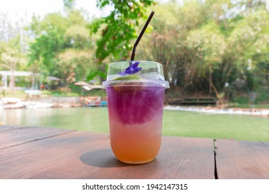 Glass Of Cold Italian Soda On Wooden Bar By Lake In Summer