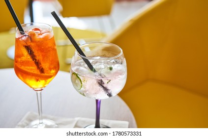 Glass Of Cold Refreshing Aperol Spritz And Gin Tonic Cocktail On Table In Summer.