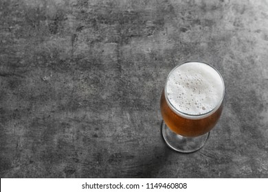 Glass With Cold Tasty Beer On Grunge Background, View From Above