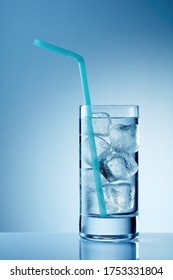 Glass Of Cold Water With Ice And Straw On Table