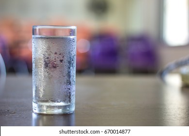 Glass Of Cold Water On Desk In Office