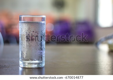 glass of cold water on desk in office
