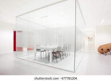 An Glass Conference Room With A Table And Chairs