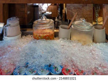 glass container of fruit salad with orange juice served with jar of homemade yogurt and packed frozen yogurt for breakfast 