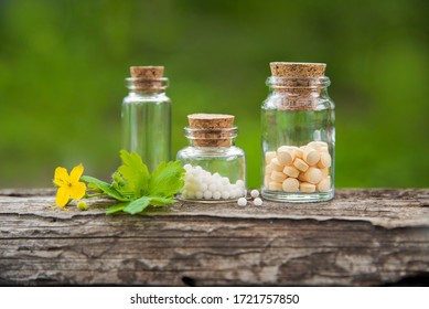 
glass containers with homeopathic granules on a beautiful natural background. homeopathy, naturopathy and alternative medicine