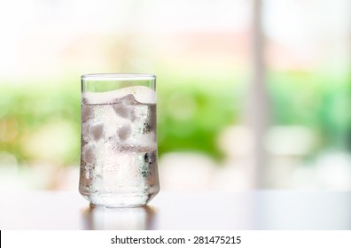 The Glass Of Cool Fresh Drink With Ice Cube On The  Table  In Living Room