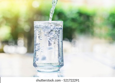 The Glass Of Cool Fresh Drink With Ice Cube And Bubble On The  Table