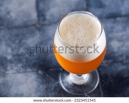 Glass of craft Indian pale ale on table with copy space