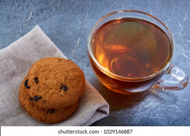 A Glass Cup Of Black Tea With Cookies On A Dark Greyish Marble Background, Shallow Depth Of Field. Breakfast Background