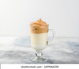 Glass cup with Dalgona frothy coffee trend korean drink latte espresso with coffee foam on light background - Powered by Shutterstock