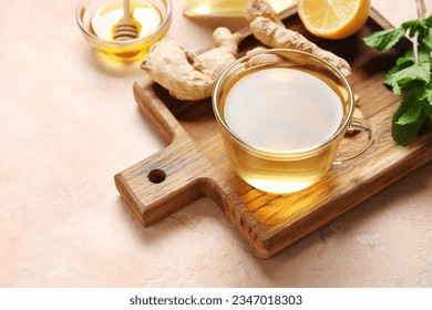 Glass cup of ginger tea and bowl with honey on pink background - Powered by Shutterstock