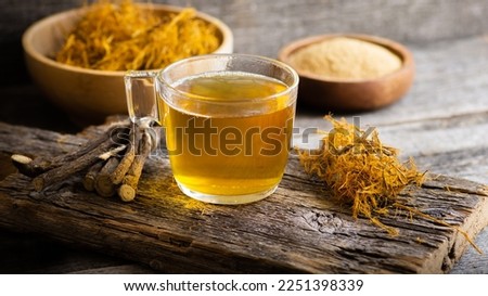 Glass cup of licorice tea with licorice root and fiber on rustic background, alternative medicine ( glycyrrhiza glabra ) Imagine de stoc © 