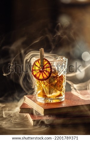 Glass cup with Old Fashioned cocktail in retro style.