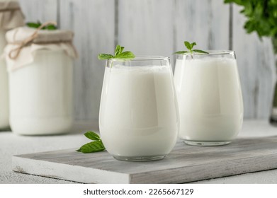 Glass cup of Turkish traditional drink ayran , kefir or buttermilk made from yogurt, healthy food