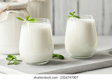 Glass cup of Turkish traditional drink ayran , kefir or buttermilk made from yogurt, healthy food - Powered by Shutterstock