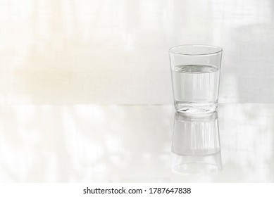 A Glass Cup/bottle Of Water On The Table(desk), Daylight In The Morning.