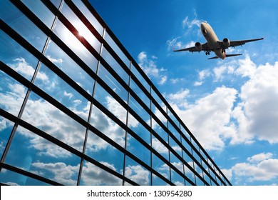 Glass Curtain Wall And Aircraft Against A Blue Sky