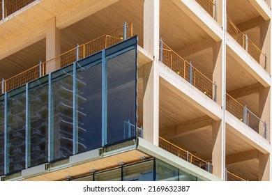 Glass curtain wall being installed on an engineered timber multi story green, sustainable, residential high rise apartment building construction project - Shutterstock ID 2169632387
