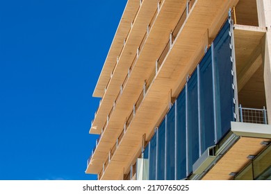 Glass curtain wall being installed on an engineered timber multi story green, sustainable, residential high rise apartment building construction project - Shutterstock ID 2170765025