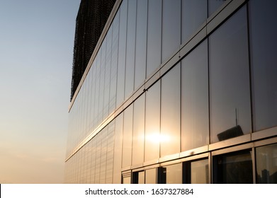 Glass curtain wall building reflecting natural light (Dusk, Sunny Day)