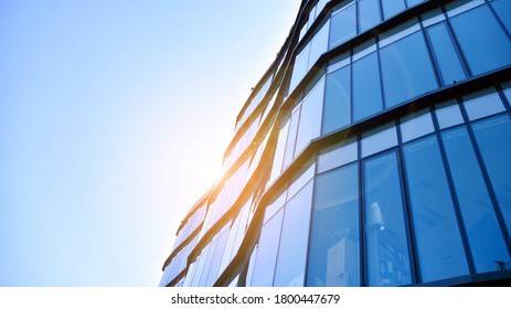 Glass curtain wall of modern office building. Modern office building on a clear sky background with sunlight.