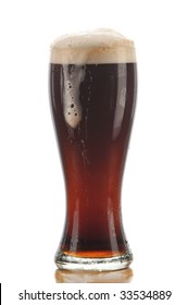 Glass Of Dark Ale Beer With Foam Drip And Reflection Isolated On White
